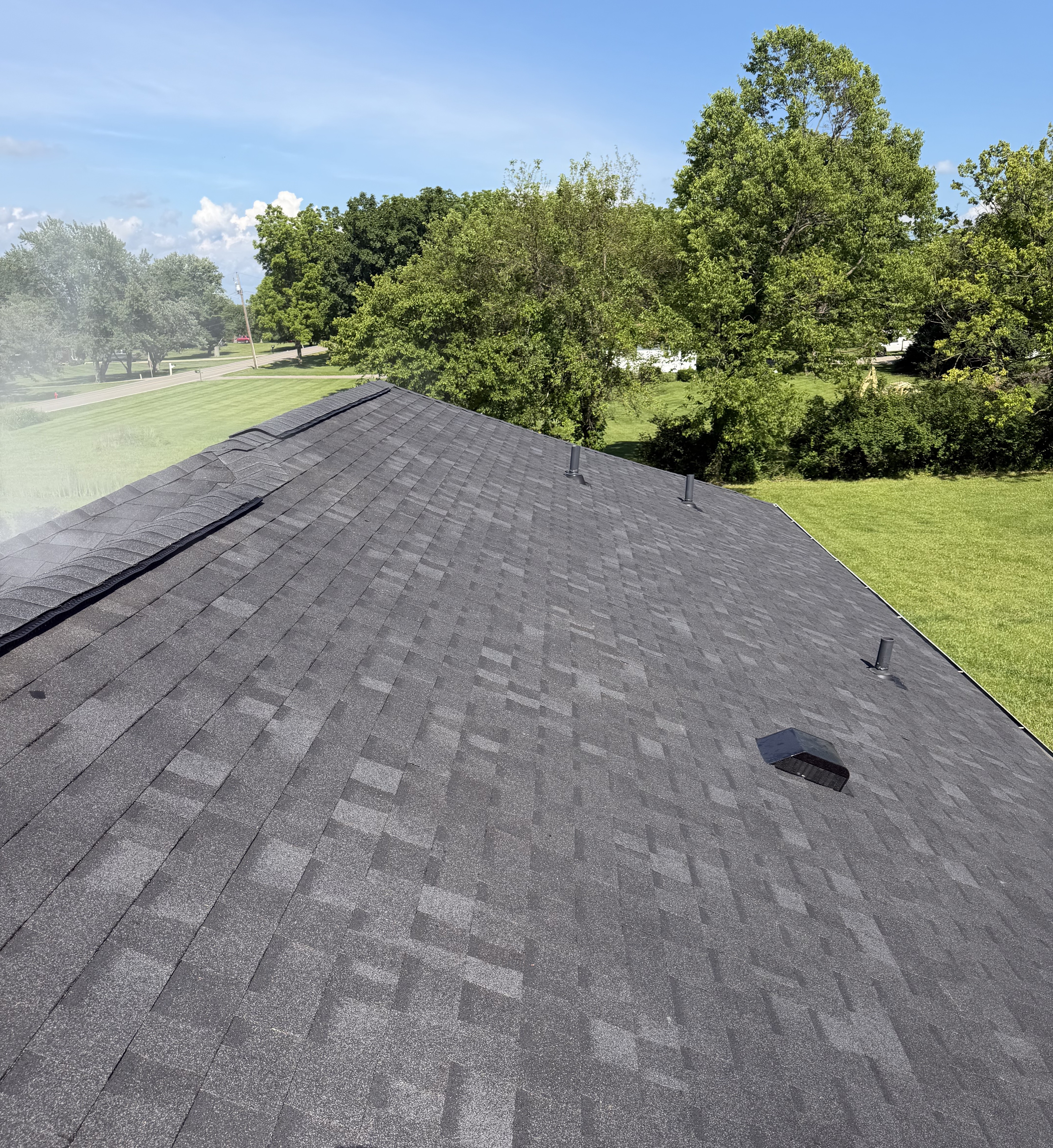 Newly installed architectural asphalt shingles on a residential roof